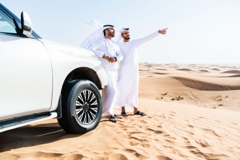 Men in desert with white SUV