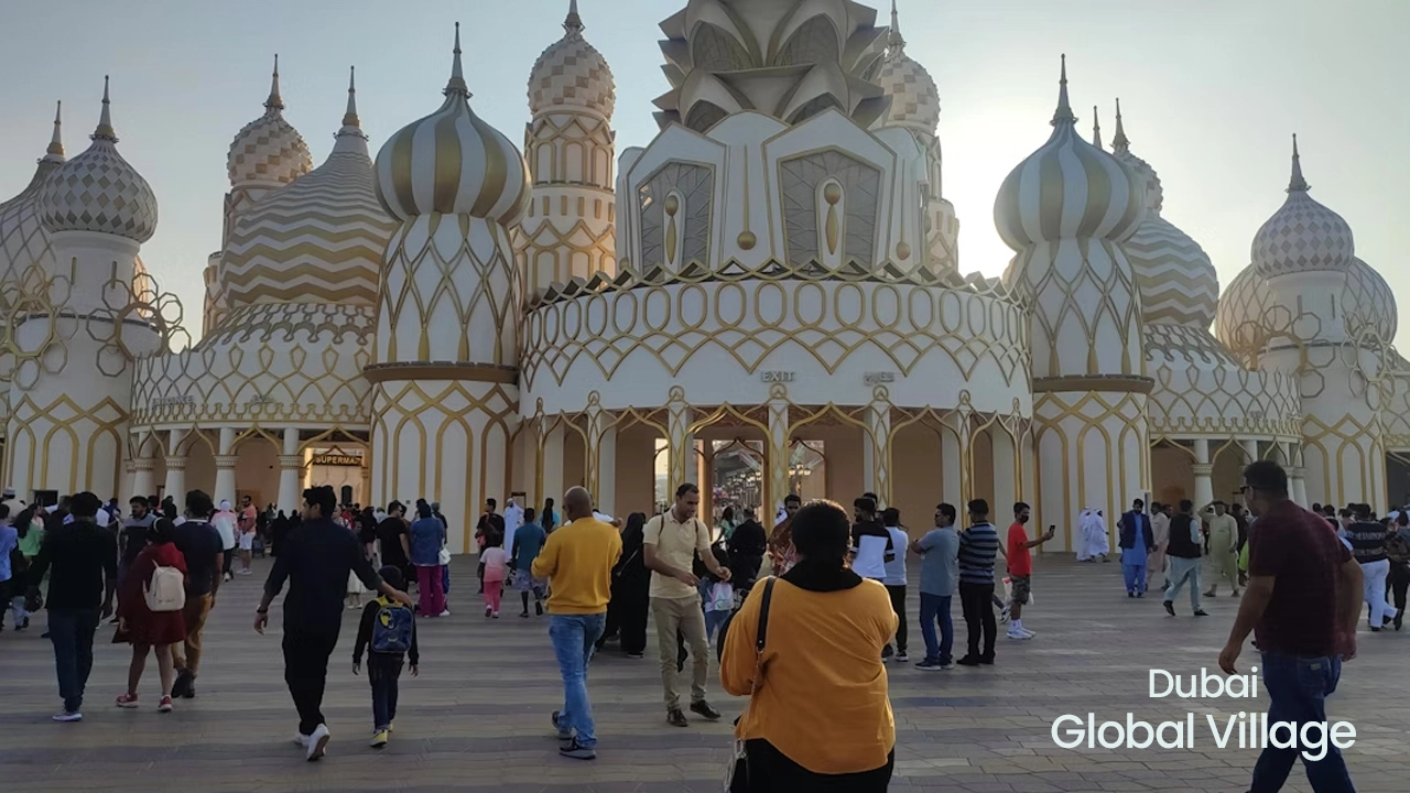 Colorful entrance view of Global Village Dubai featuring international pavilions, lights, and cultural attractions