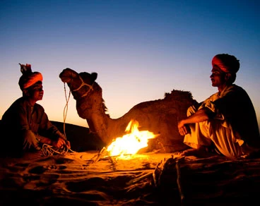 Guests enjoying dinner during overnight desert safari